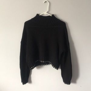 Cropped black high neck sweater with white trim
